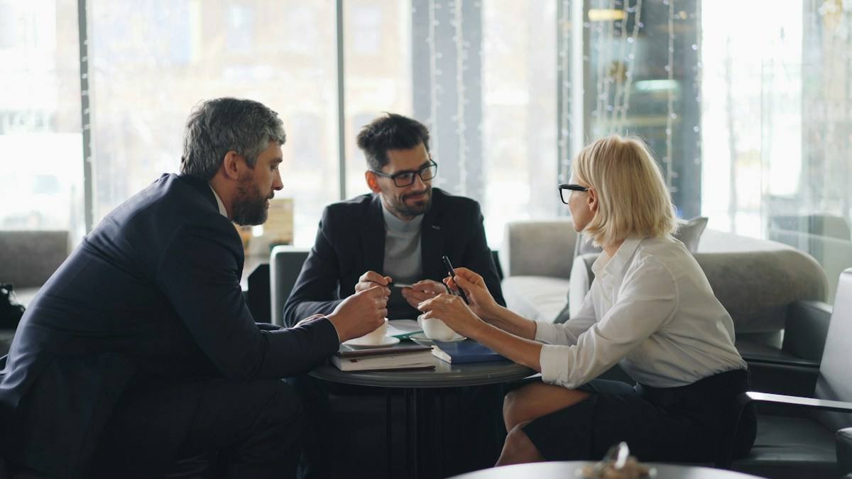 A mixed team working together around a table