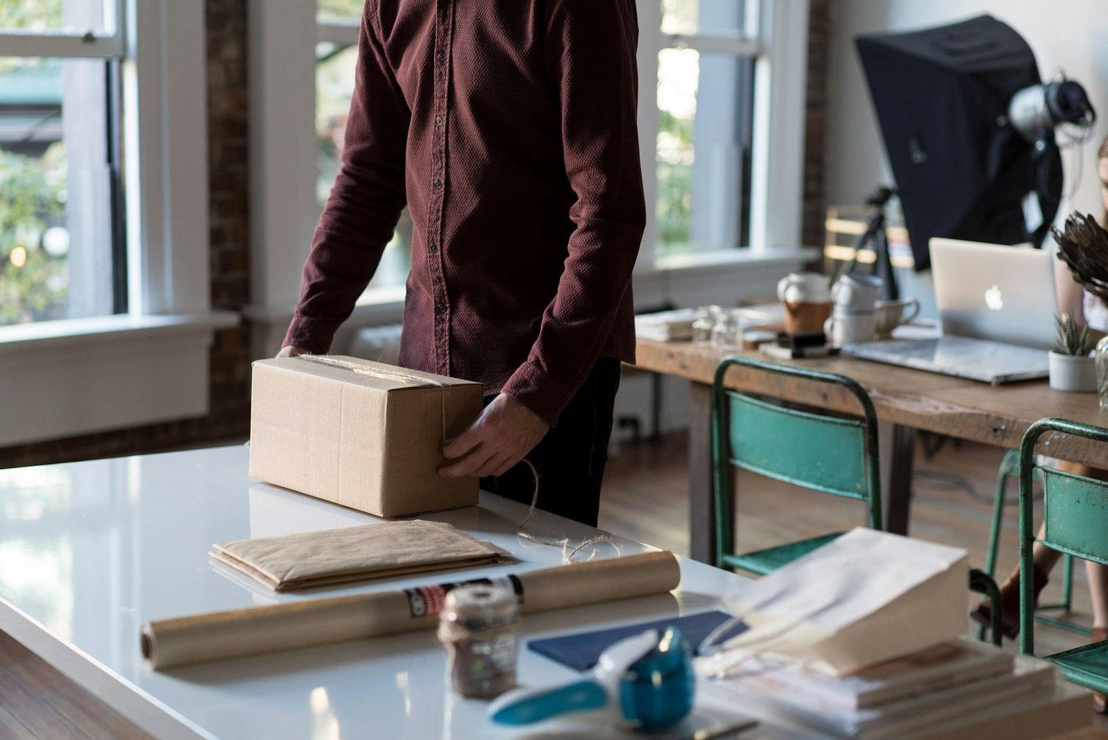 A business owner packing an order for shipment