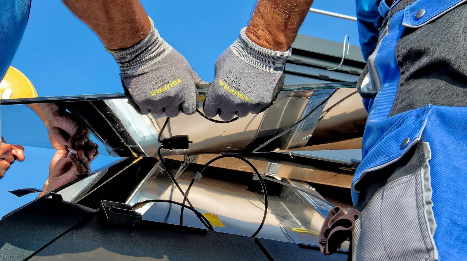 Two installers fitting solar panels together