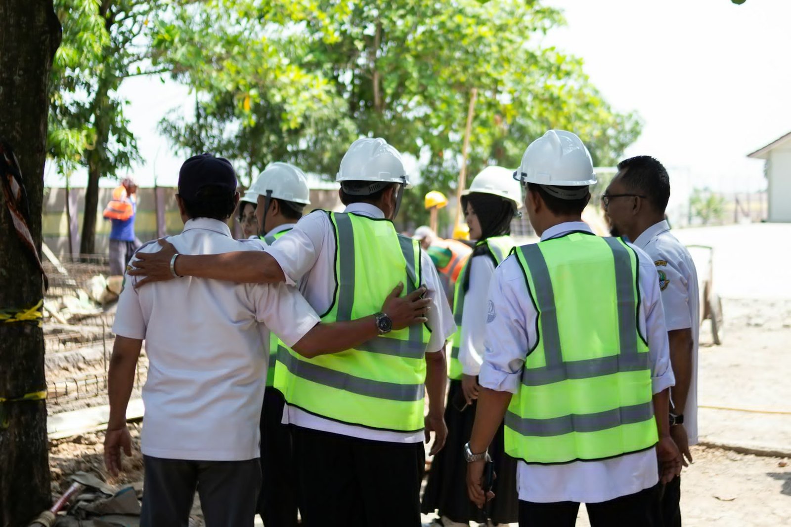 A construction team in hard hats at work on site